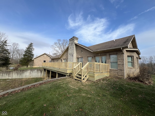 back of house featuring a wooden deck and a yard