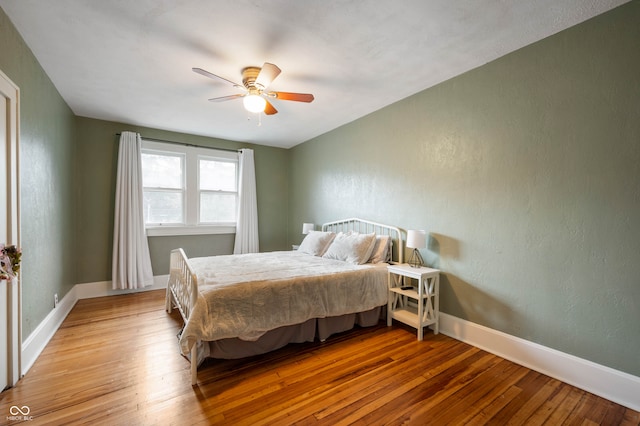 bedroom with ceiling fan and light wood-type flooring