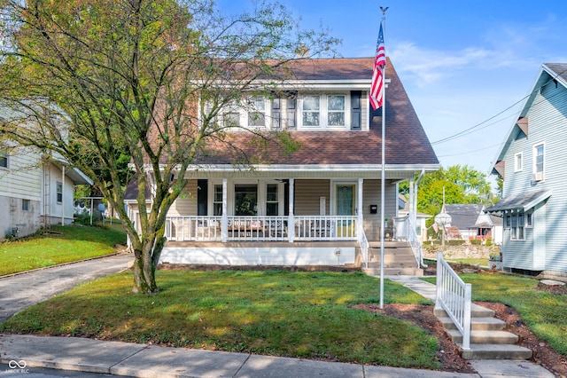 view of front of home with a front yard and covered porch