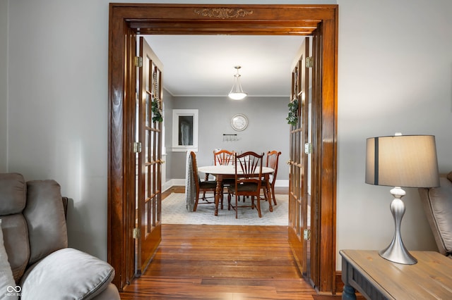 dining room with wood-type flooring and ornamental molding