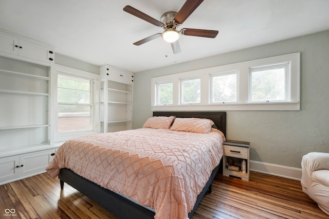 bedroom with ceiling fan, light wood-type flooring, and multiple windows