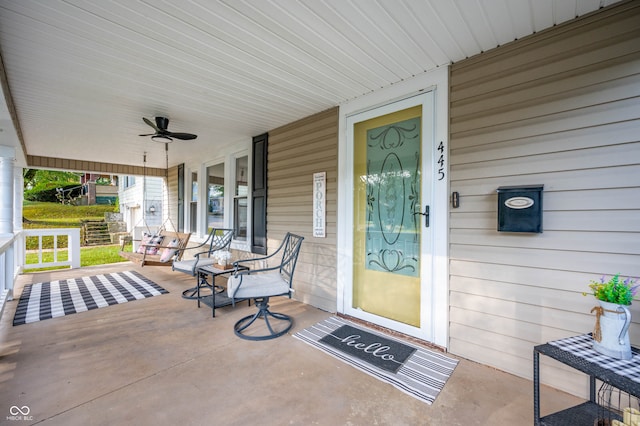 property entrance with ceiling fan and a porch