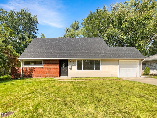 view of front of property with a garage and a front lawn