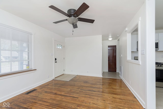 entrance foyer with dark hardwood / wood-style flooring and ceiling fan