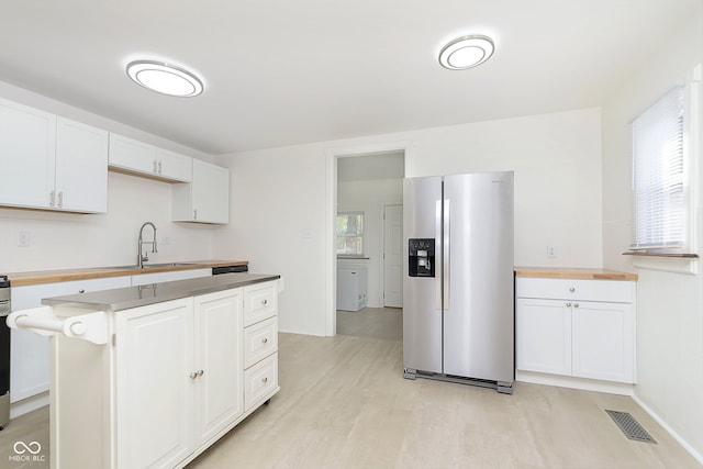 kitchen with a center island, light hardwood / wood-style flooring, white cabinetry, sink, and stainless steel refrigerator with ice dispenser