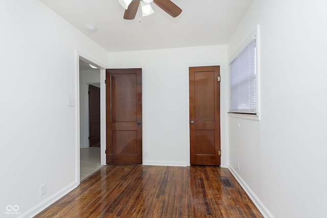 unfurnished bedroom featuring dark hardwood / wood-style flooring and ceiling fan