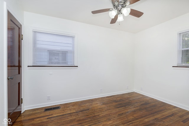 unfurnished room with dark hardwood / wood-style flooring and ceiling fan