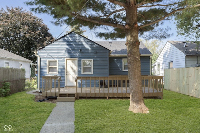 bungalow-style home featuring a wooden deck and a front lawn