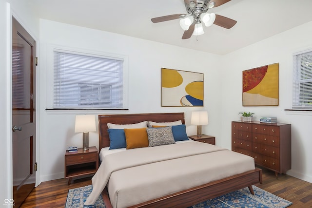 bedroom with ceiling fan and dark hardwood / wood-style floors