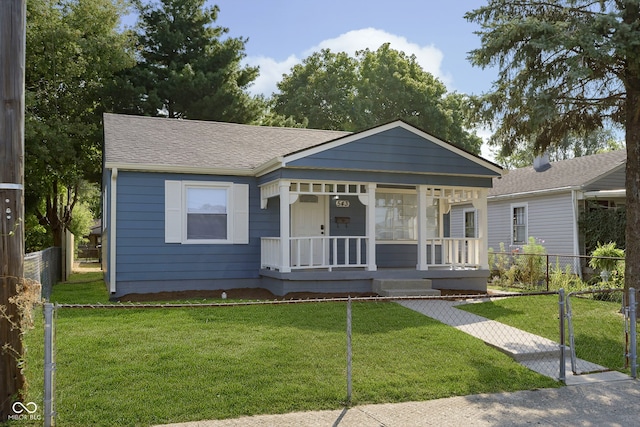 bungalow featuring a porch and a front lawn