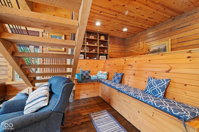 living area with wood ceiling, dark hardwood / wood-style floors, and wood walls