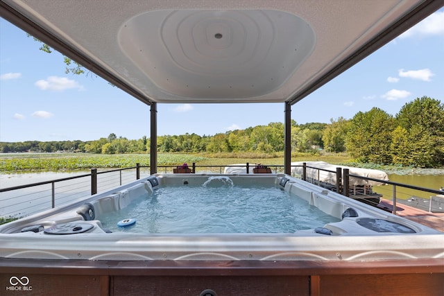 view of swimming pool with a hot tub