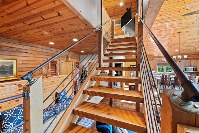 stairs featuring rustic walls, wood walls, and wooden ceiling