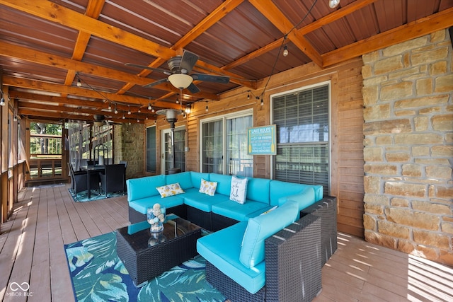 wooden deck with outdoor lounge area and ceiling fan