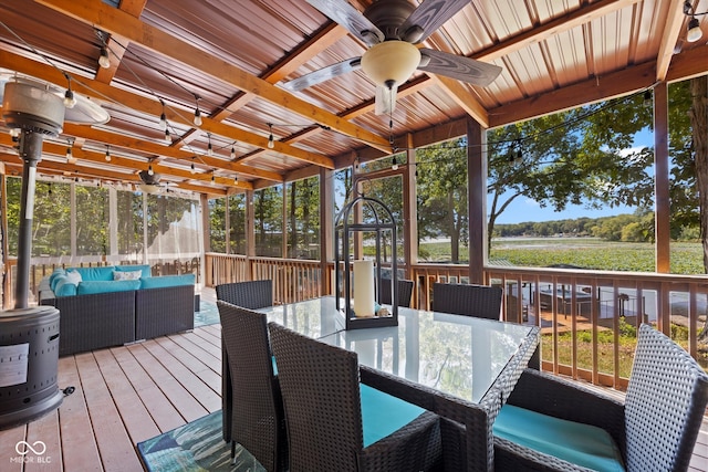 sunroom with beam ceiling and ceiling fan