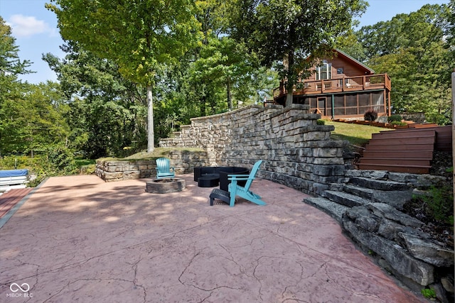 view of patio featuring a wooden deck and an outdoor fire pit