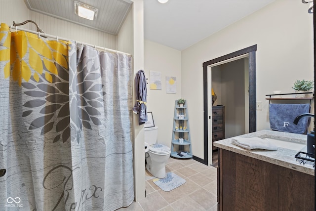 bathroom featuring tile patterned floors, vanity, and toilet