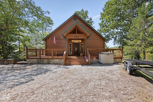 log home with a wooden deck