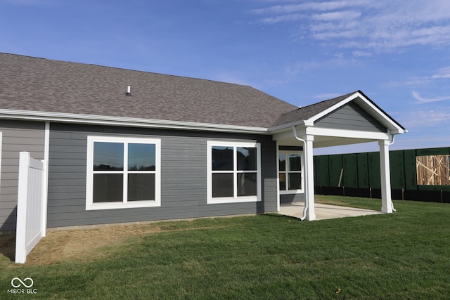 back of house featuring a lawn and a patio