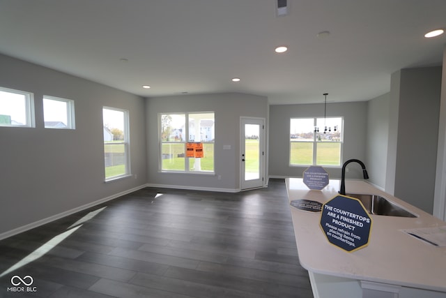 interior space with dark hardwood / wood-style flooring, a notable chandelier, and sink