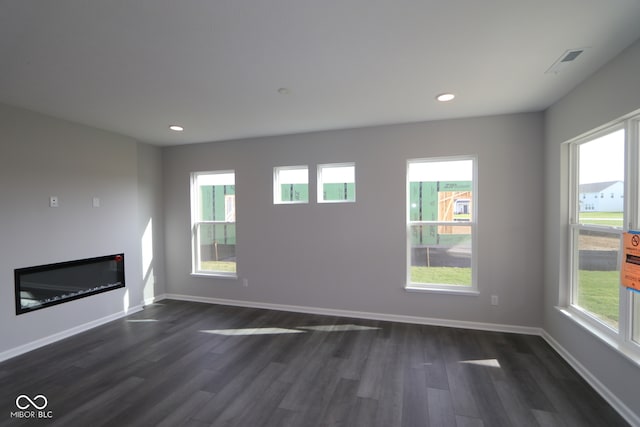 unfurnished living room featuring dark wood-type flooring