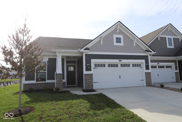 craftsman house with a garage and a front yard