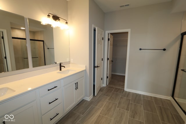 bathroom with walk in shower and vanity