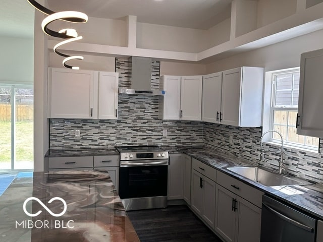 kitchen with stainless steel appliances, a healthy amount of sunlight, and sink