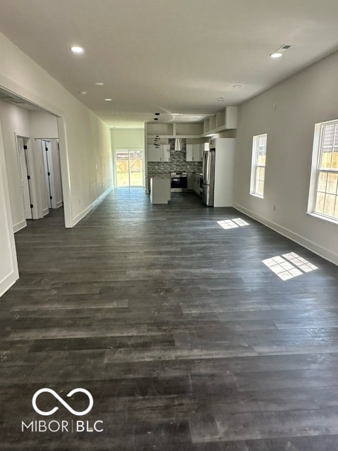 unfurnished living room featuring dark wood-type flooring