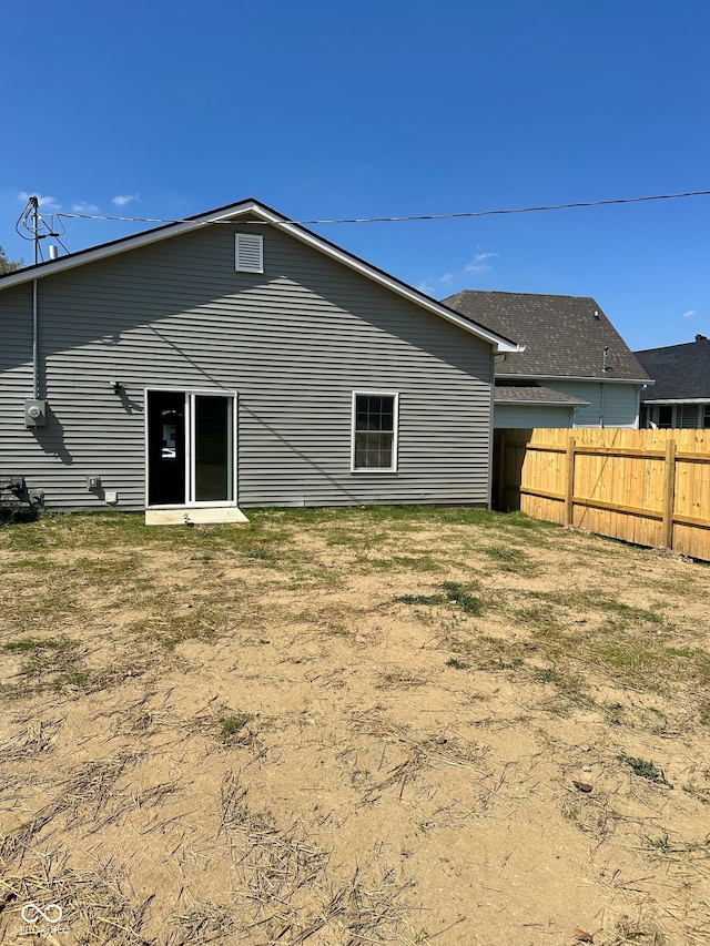 rear view of property with a lawn