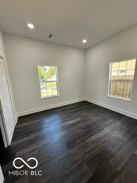 unfurnished room featuring dark hardwood / wood-style flooring