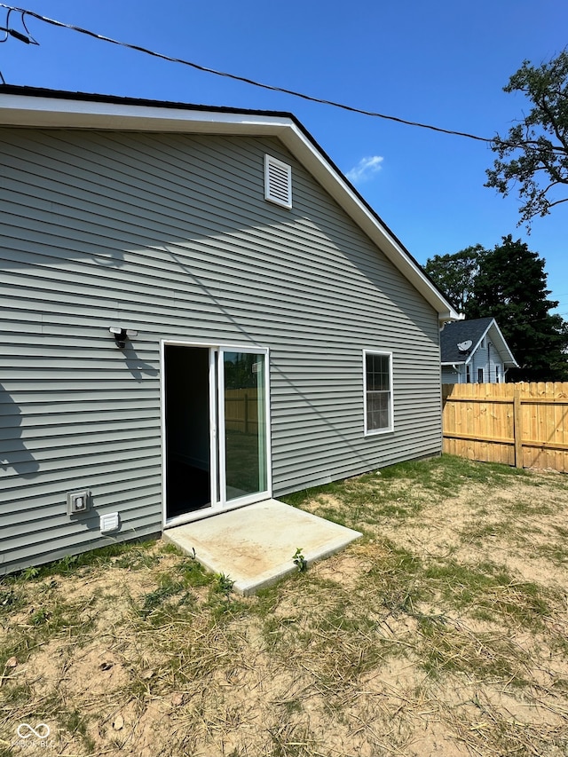 rear view of house featuring a lawn