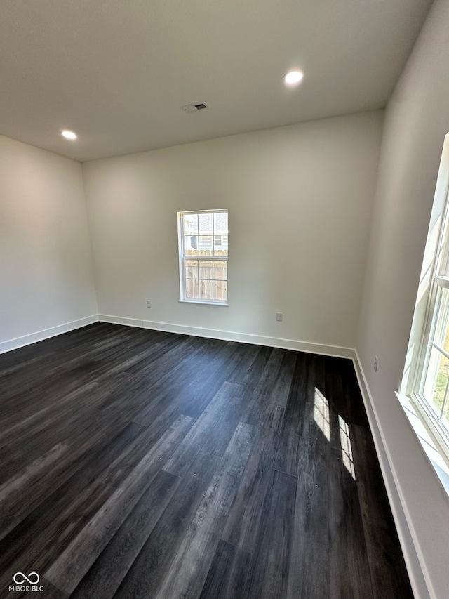 unfurnished room featuring dark hardwood / wood-style flooring