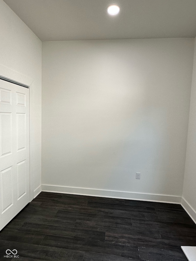 empty room with dark hardwood / wood-style floors