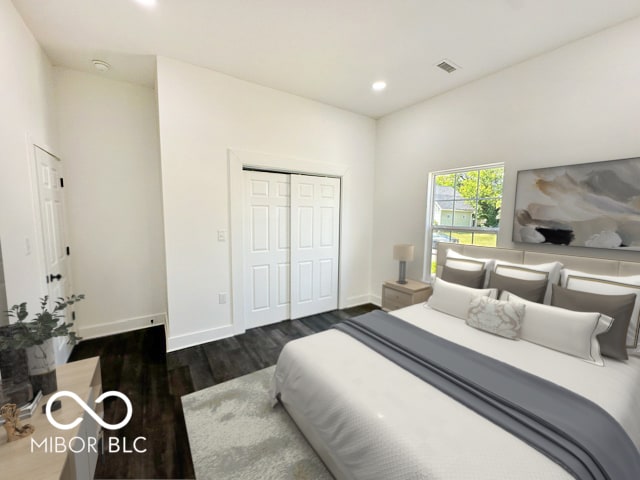 bedroom featuring dark hardwood / wood-style floors and a closet