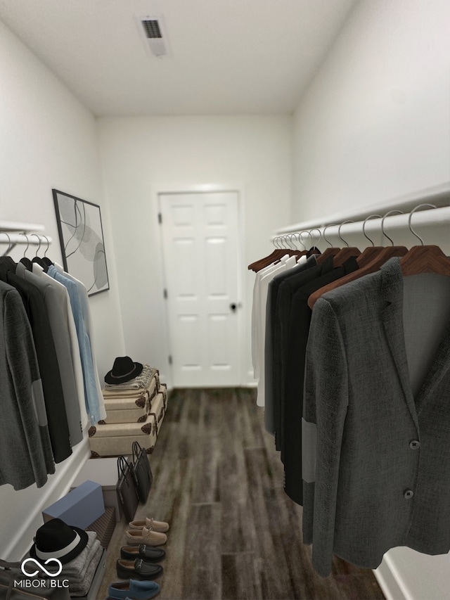 walk in closet featuring dark colored carpet