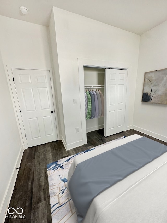 bedroom featuring dark hardwood / wood-style flooring and a closet