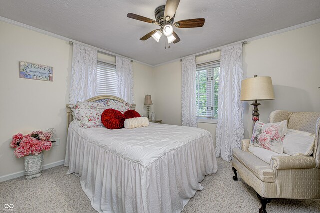 carpeted bedroom featuring a textured ceiling, ceiling fan, and ornamental molding