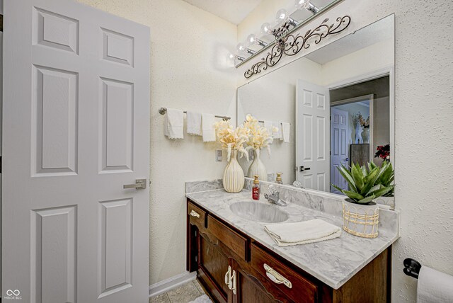 bathroom featuring tile patterned flooring and vanity