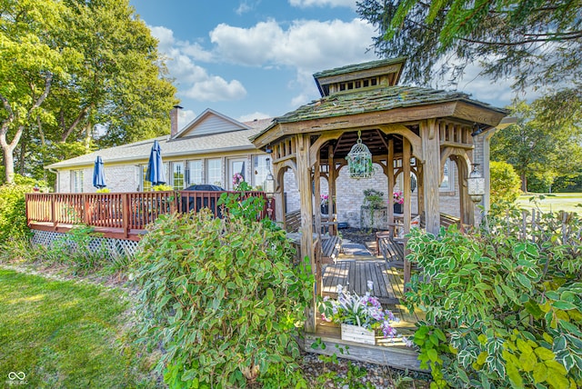 back of property with a gazebo and a deck