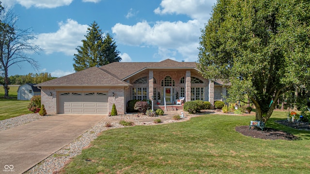 ranch-style house featuring a garage, french doors, and a front lawn