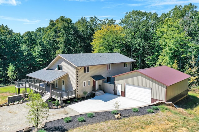 view of front of house featuring an outdoor structure, a wooden deck, and a garage