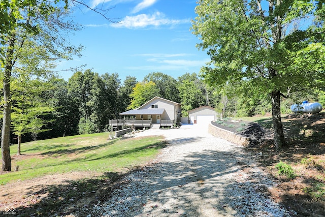 view of front facade with an outbuilding, a garage, and a front lawn