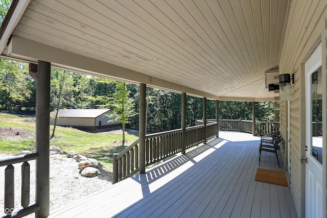 wooden deck with a lawn