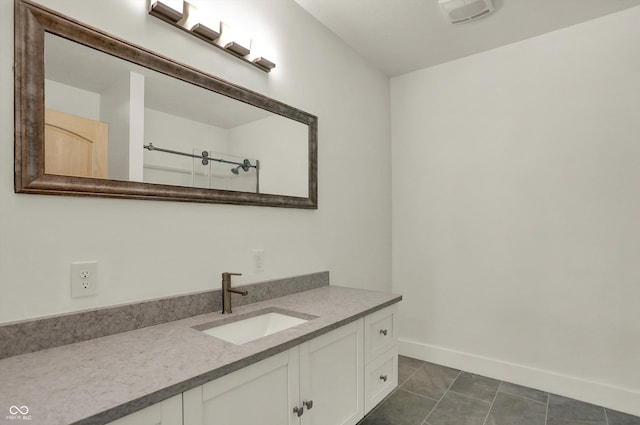 bathroom with tile patterned flooring and vanity