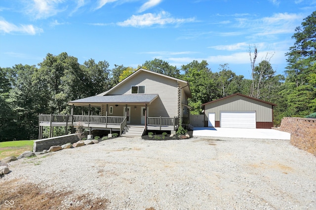 view of front facade featuring an outbuilding, a wooden deck, and a garage