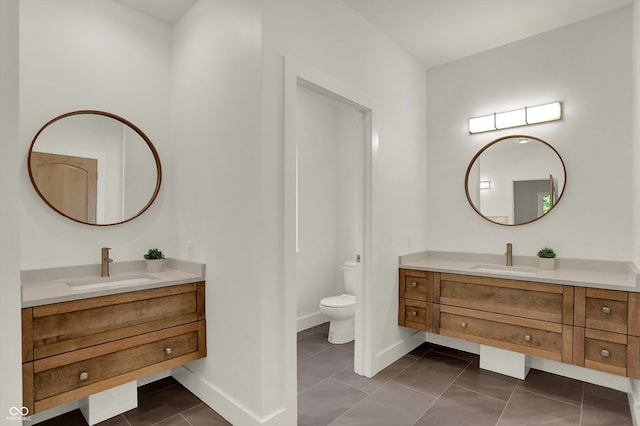 bathroom with tile patterned floors, toilet, and vanity