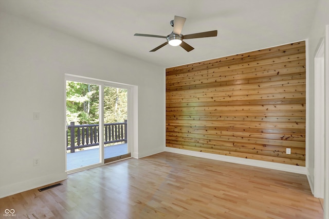 spare room featuring ceiling fan and light hardwood / wood-style flooring