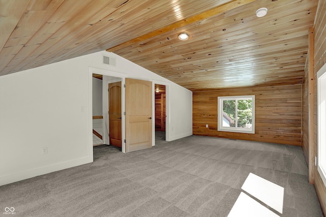 bonus room with lofted ceiling, light colored carpet, and wood ceiling