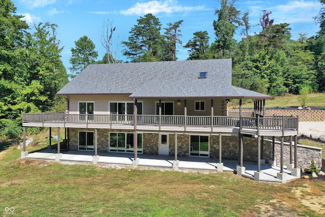 rear view of property with a yard, a patio, and a deck